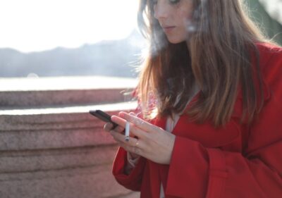 woman in red searching for cigarettes on online