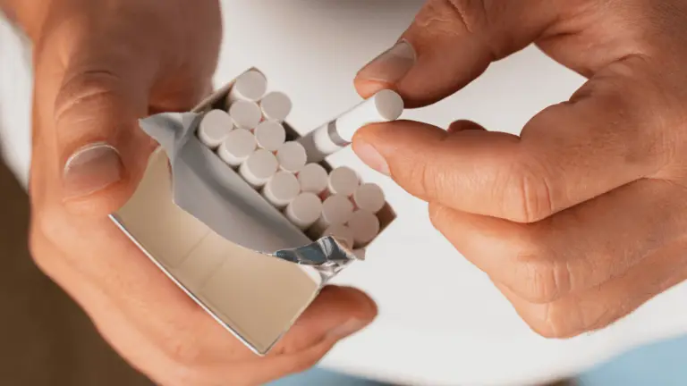 man holding small king cigarette pack